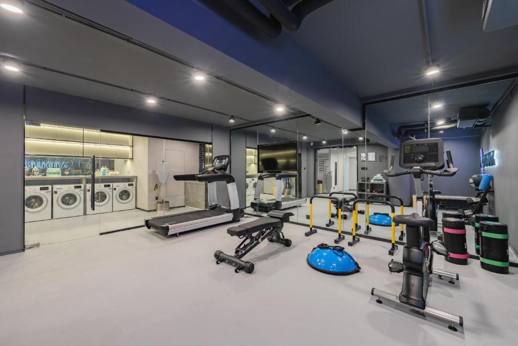 a gym with several treadmills and machines in a room at Atour Hotel Hangzhou West Lake Hubin North Zhongshan Road in Hangzhou