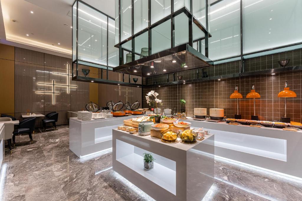 a restaurant with a buffet line with food on display at Atour Hotel Huzhou City Government in Huzhou