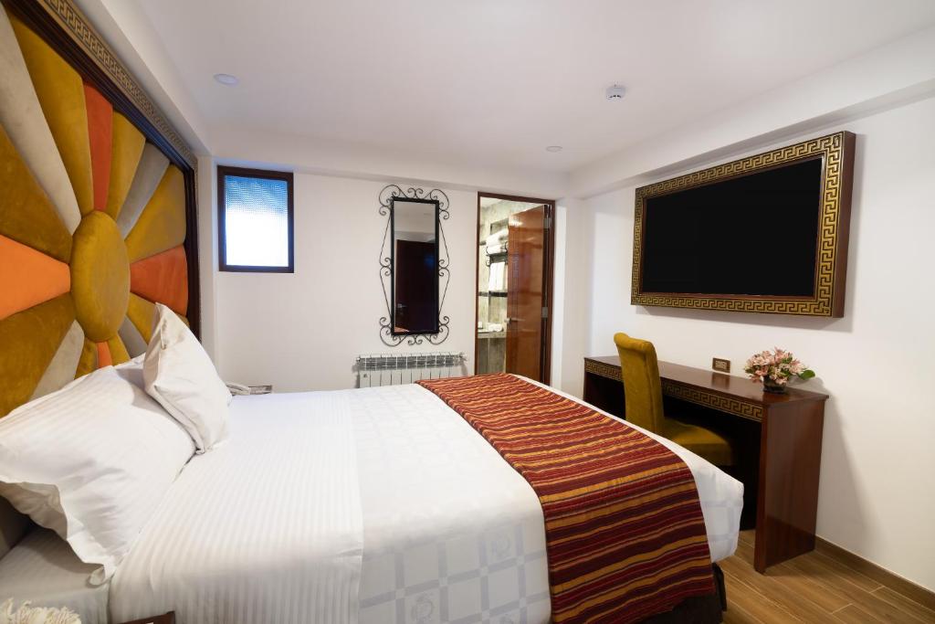 Postel nebo postele na pokoji v ubytování Hotel Hacienda Cusco Centro Historico