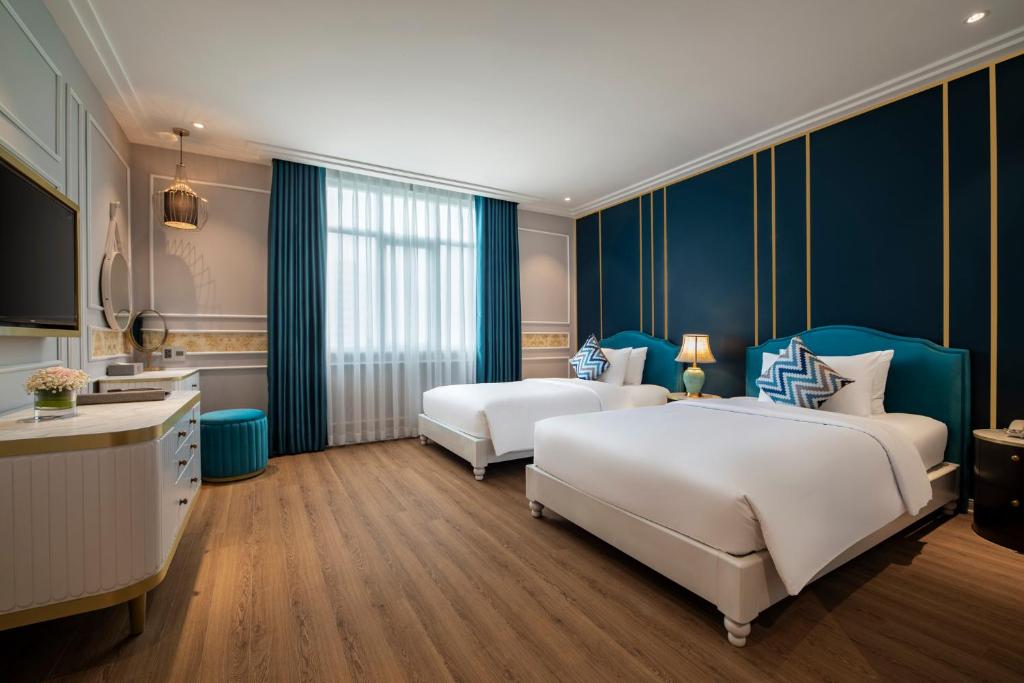Postel nebo postele na pokoji v ubytování Angel Hotels Beach Danang