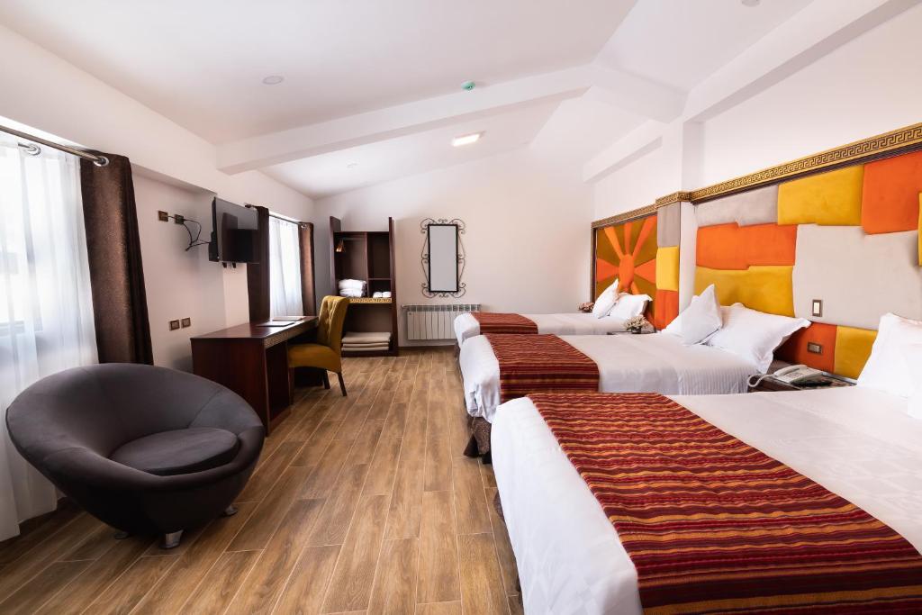 Postel nebo postele na pokoji v ubytování Hotel Hacienda Cusco Centro Historico