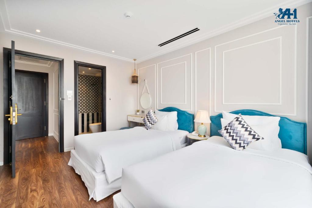 Postel nebo postele na pokoji v ubytování Angel Hotels Beach Danang