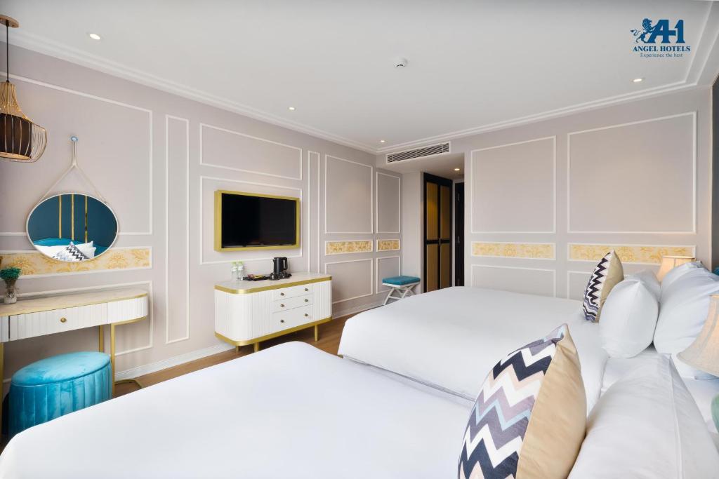 Postel nebo postele na pokoji v ubytování Angel Hotels Beach Danang