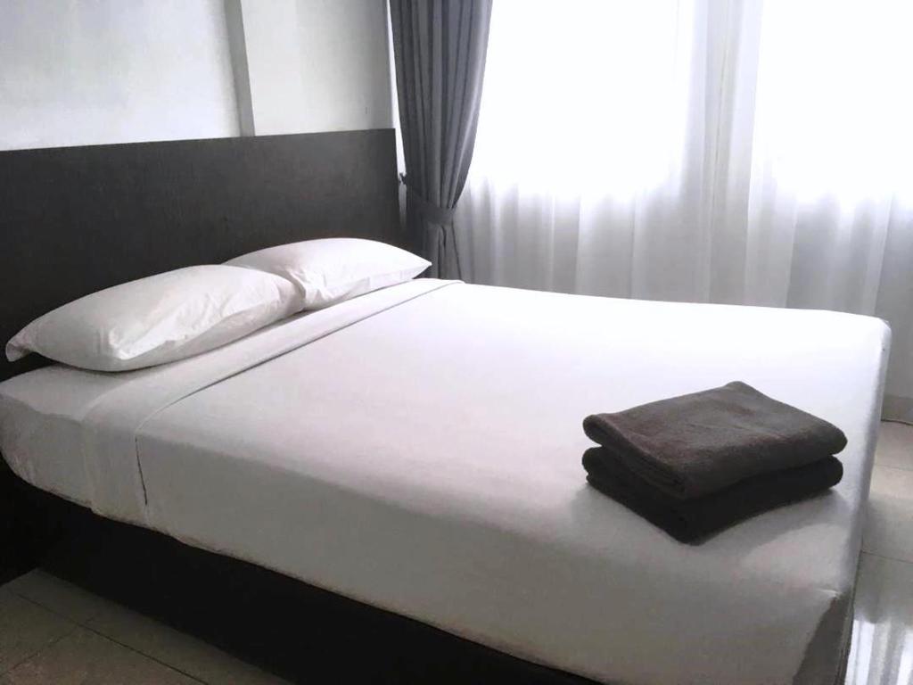 Postel nebo postele na pokoji v ubytování Desaru, Bayu Balau Beach Resort