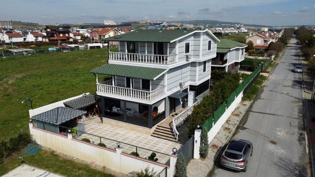 a large white house with a green roof at Rizk Villa sea view villa in silivri , istanbul in Silivri