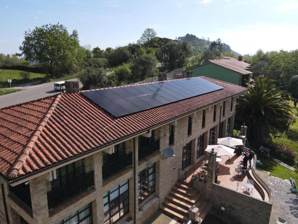 an overhead view of a building with solar panels on the roof at Prau Riu Hotel Hyundai-Asturdai in Llanes