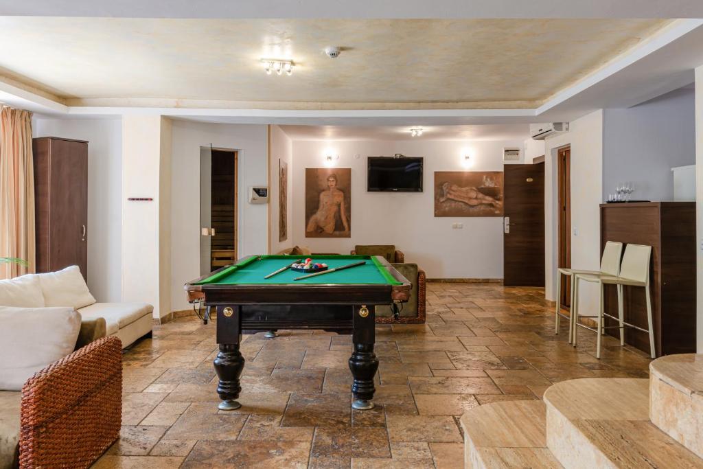 a living room with a pool table in it at Hotel Grand in Eforie Nord