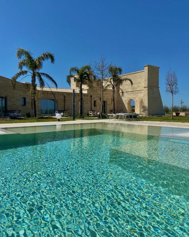 a large pool of water in front of a building at PODERE CARAFA in Nardò
