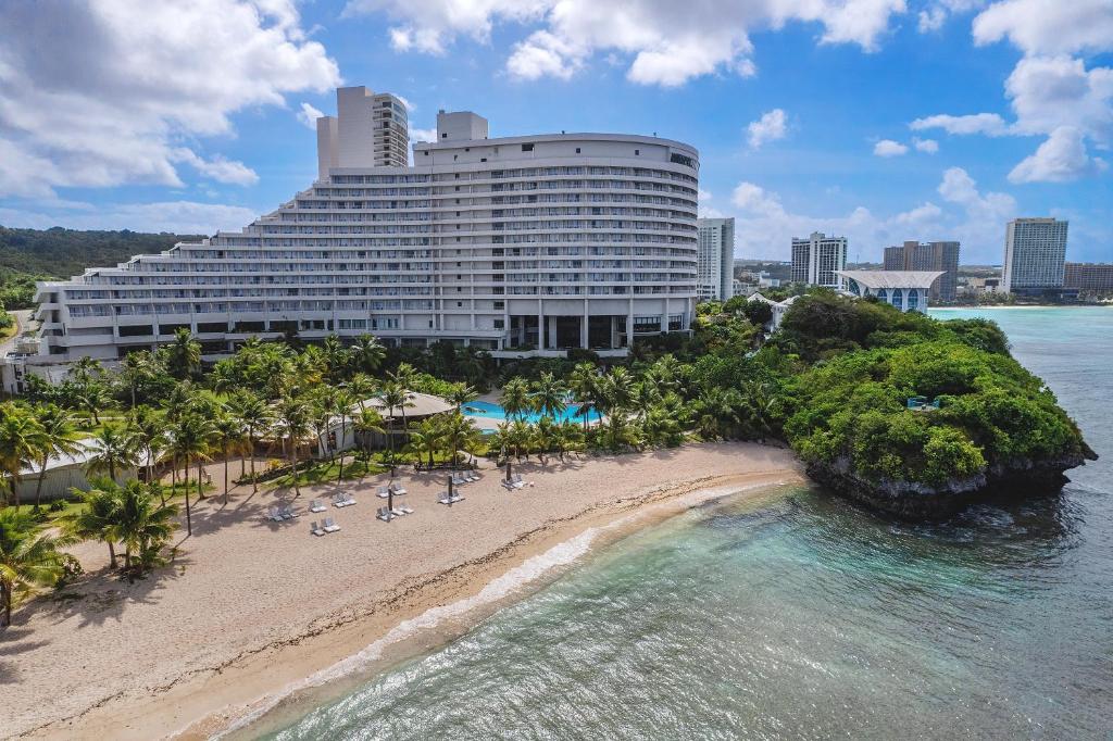 a hotel on a beach next to the ocean at Hotel Nikko Guam in Tumon