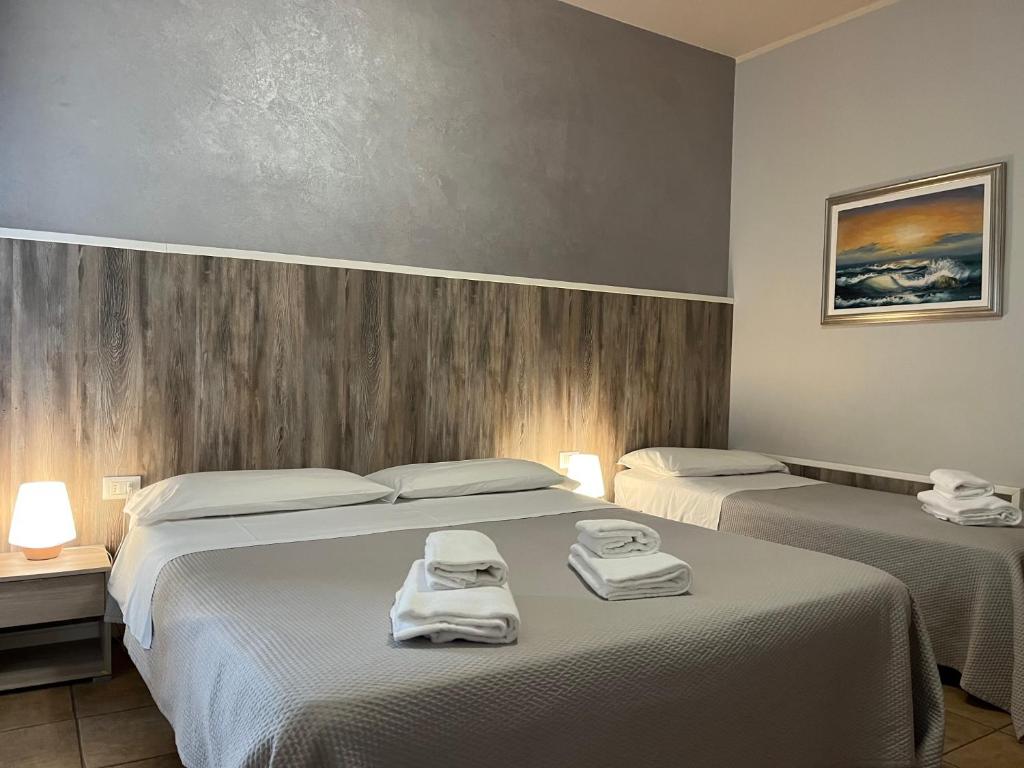 Postel nebo postele na pokoji v ubytování Hotel Renata