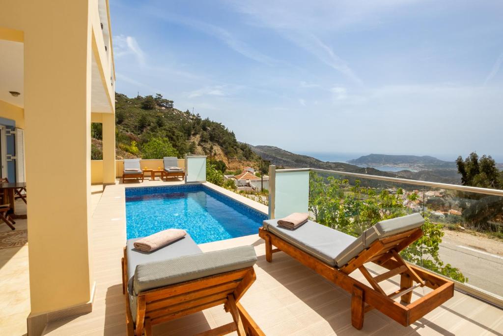 a villa with a swimming pool and a balcony at Karpathos View Villa in Karpathos