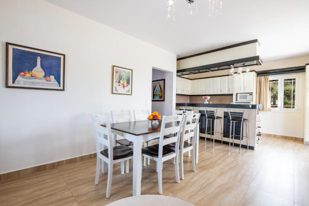 a kitchen and dining room with a table and chairs at Karpathos View Villa in Karpathos