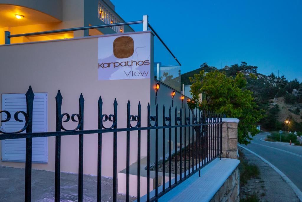 a black fence in front of a building at Karpathos View Villa in Karpathos