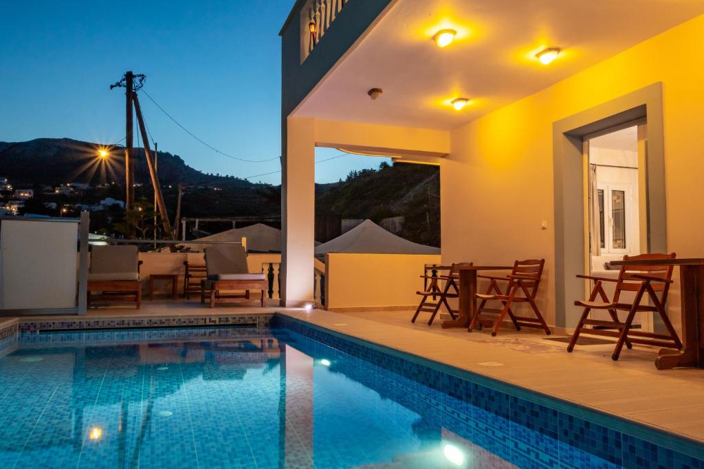 a villa with a swimming pool at night at Karpathos View Villa in Karpathos