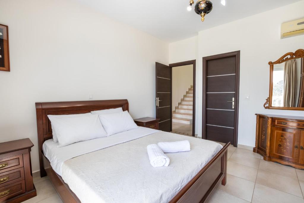 a bedroom with a bed with two towels on it at Karpathos View Villa in Karpathos