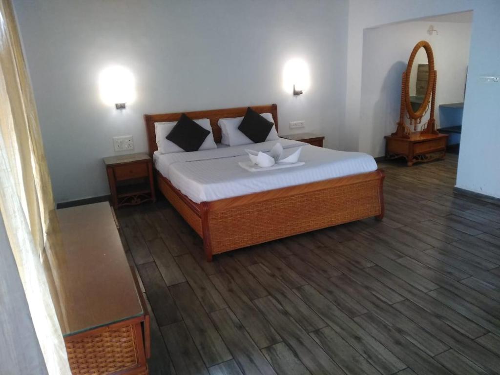 Giường trong phòng chung tại Vraksh by Aranyak