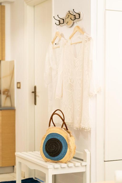 a white room with a white shirt and a basket at Esperides Studios in Syvota