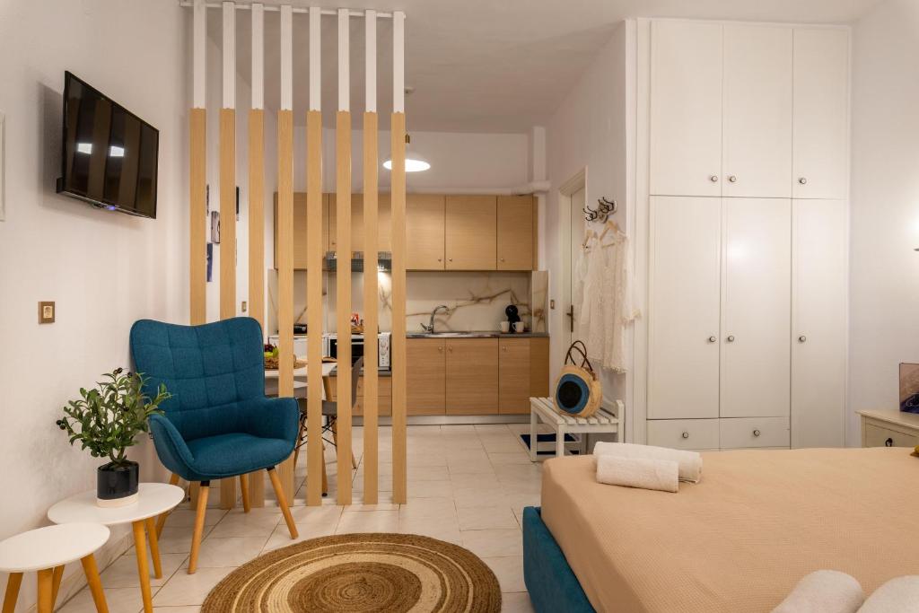 a living room with a bed and a kitchen at Esperides Studios in Syvota