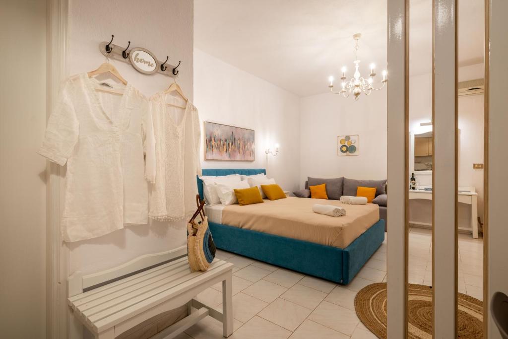 a bedroom with a bed and a clothes rack at Esperides Studios in Syvota