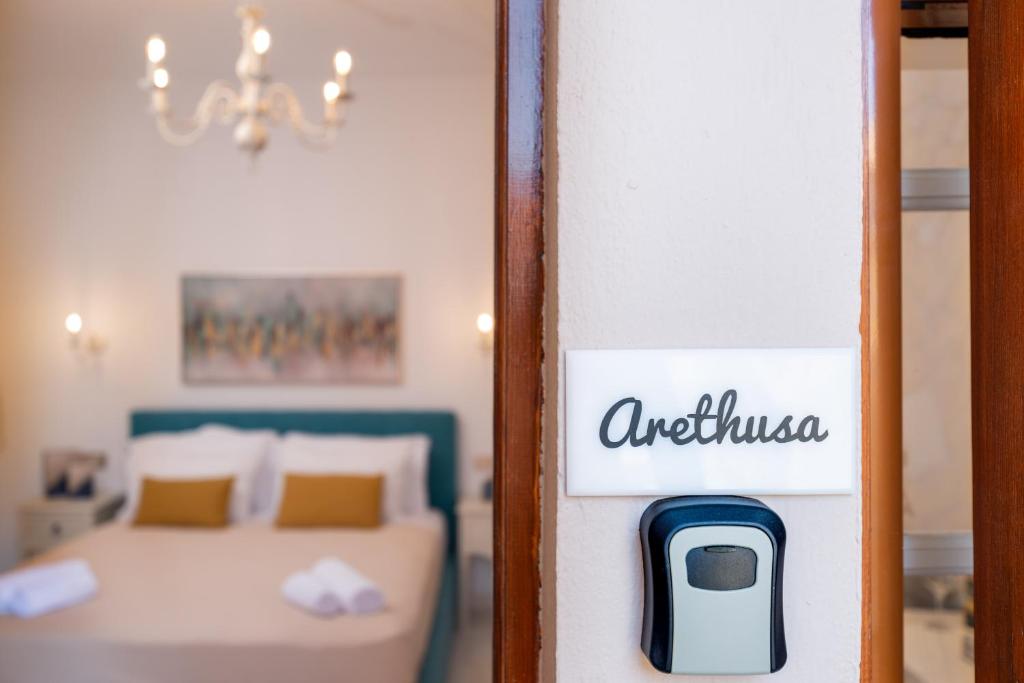 a room with a bed and a sign that reads outpatient at Esperides Studios in Syvota