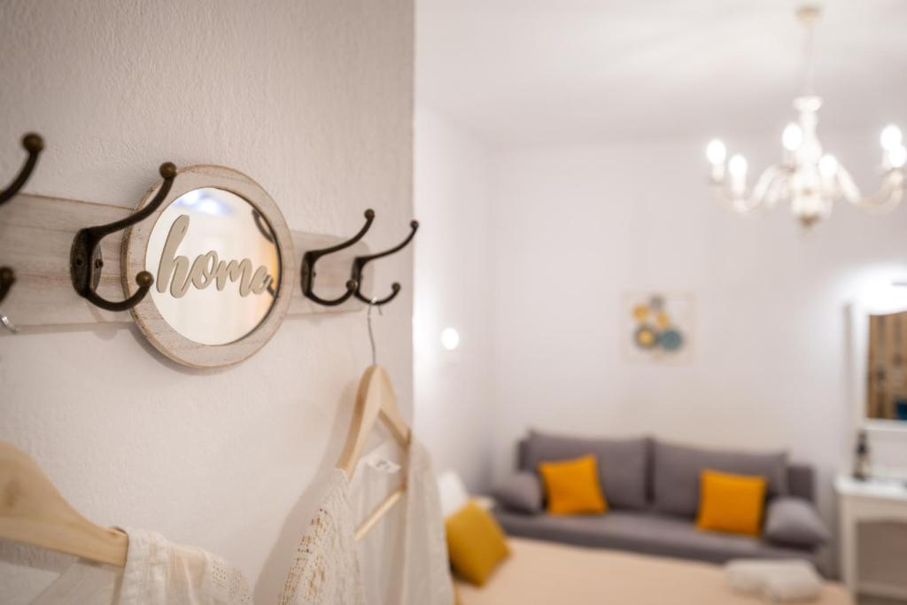 a mirror on the wall of a room with a couch at Esperides Studios in Syvota