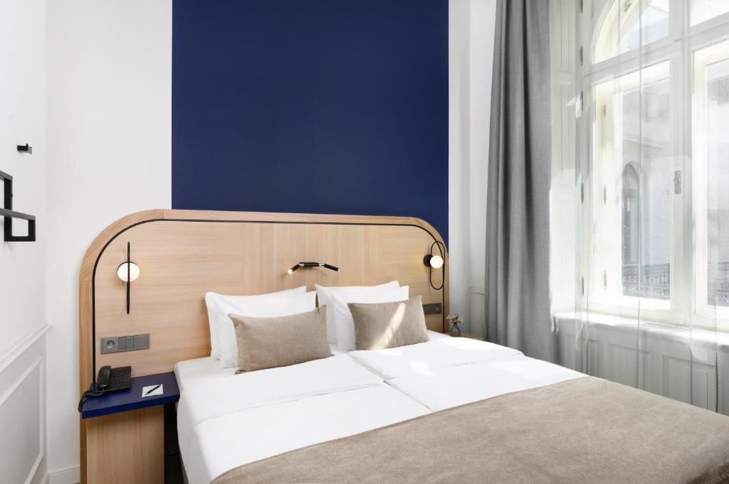 Posteľ alebo postele v izbe v ubytovaní Hotel Oktogon Haggenmacher by Continental Group