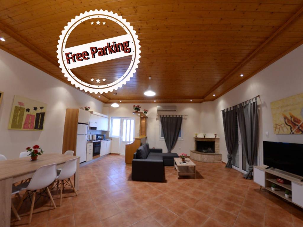 a living room with a free parking sign on the ceiling at Patras Cozy Lodge in Patra