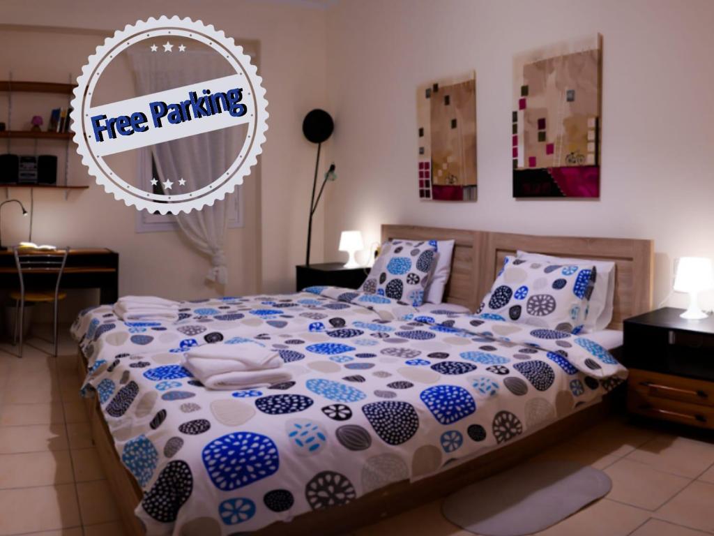a bedroom with a bed with a free parking sign on it at Patras Palm Tree in Patra