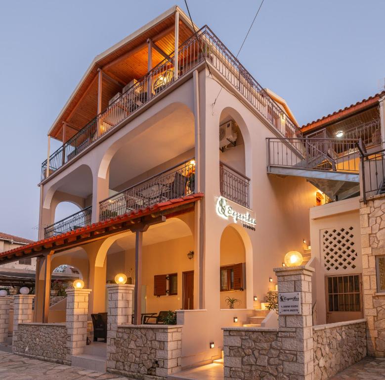 a large building with a balcony on top of it at Esperides Studios in Syvota