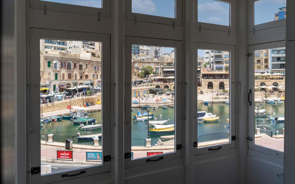a view of a harbor from a window at The Rose Hostel in St. Julianʼs