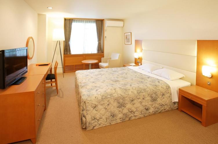 Postel nebo postele na pokoji v ubytování Tabist Hotel Colosseum Inn Tateshina