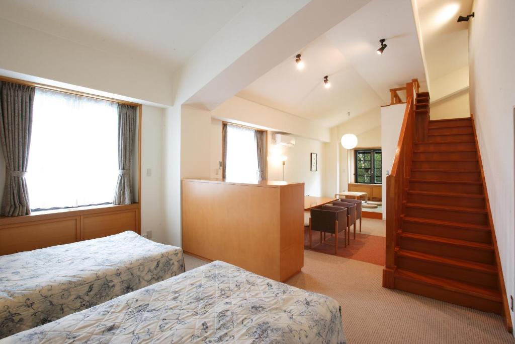 Postel nebo postele na pokoji v ubytování Tabist Hotel Colosseum Inn Tateshina