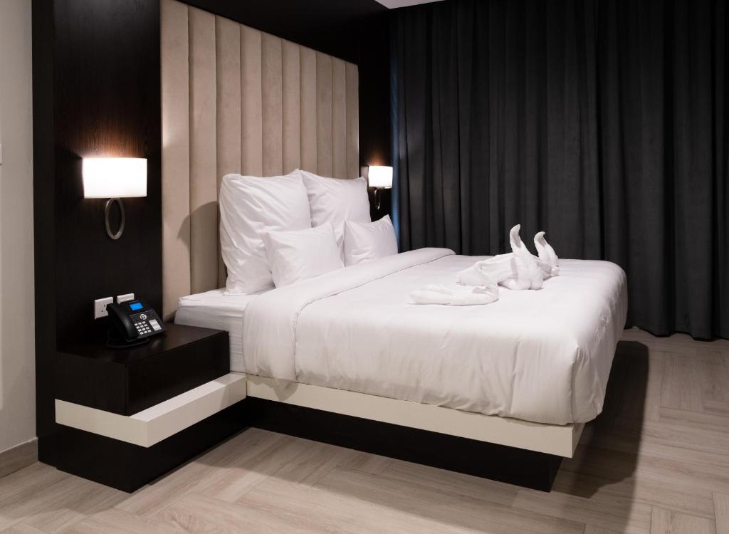 Postel nebo postele na pokoji v ubytování Mirot Hotel