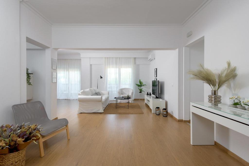 a white living room with a couch and a chair at Harmony Elegant Central Apartment in Rhodes Town