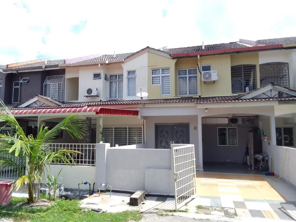 a house with a fence in front of it at holiday home bagan lalang 5 aircon in Kampong Bagan Lalang