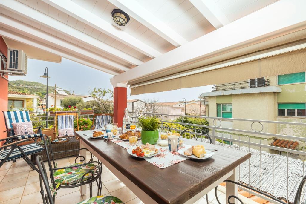 a table on a balcony with food on it at Coastal Home in Santa Maria Navarrese