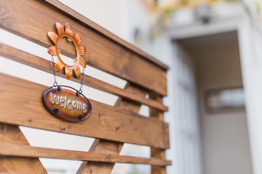 a sign on the side of a wooden bench at HOUSE NEFELI in Témeni