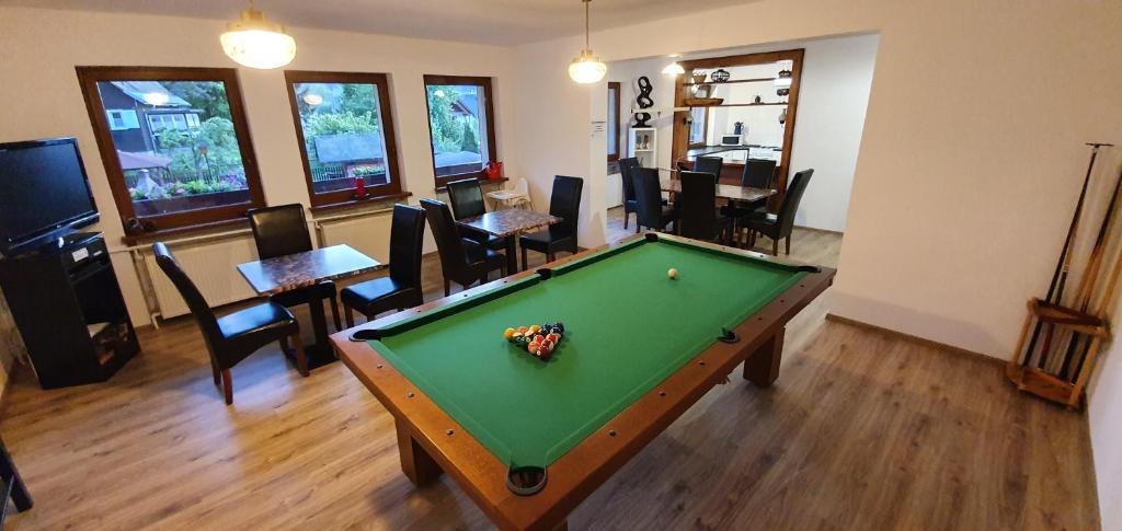 a room with a pool table and a dining room at ORION in Karpacz