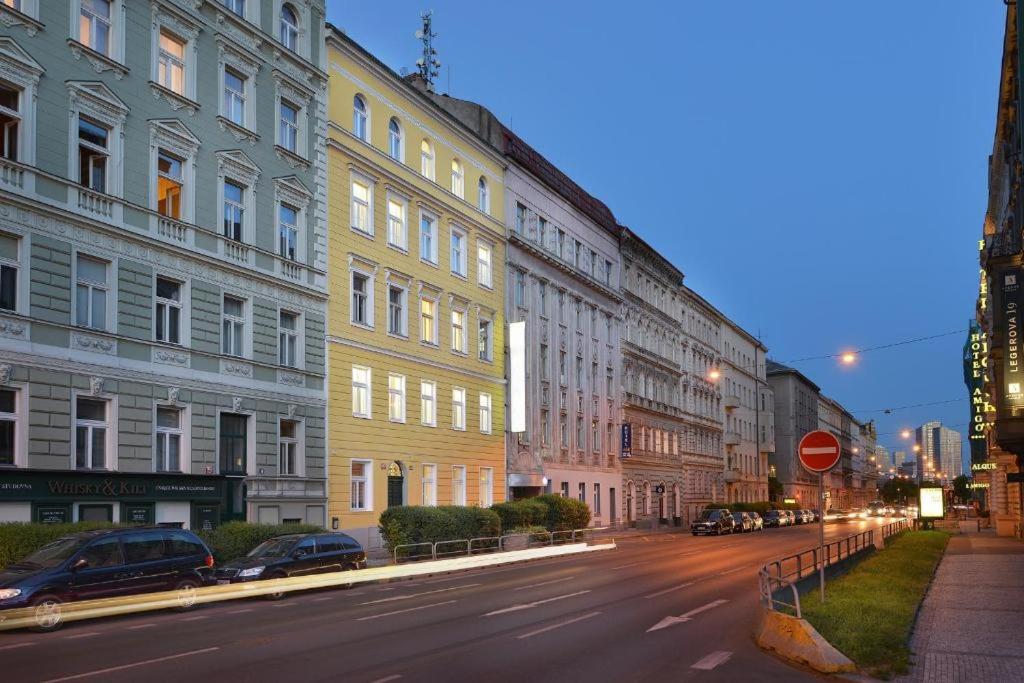 a city street with many buildings and a stop sign at Prague Season Three Stars in Prague