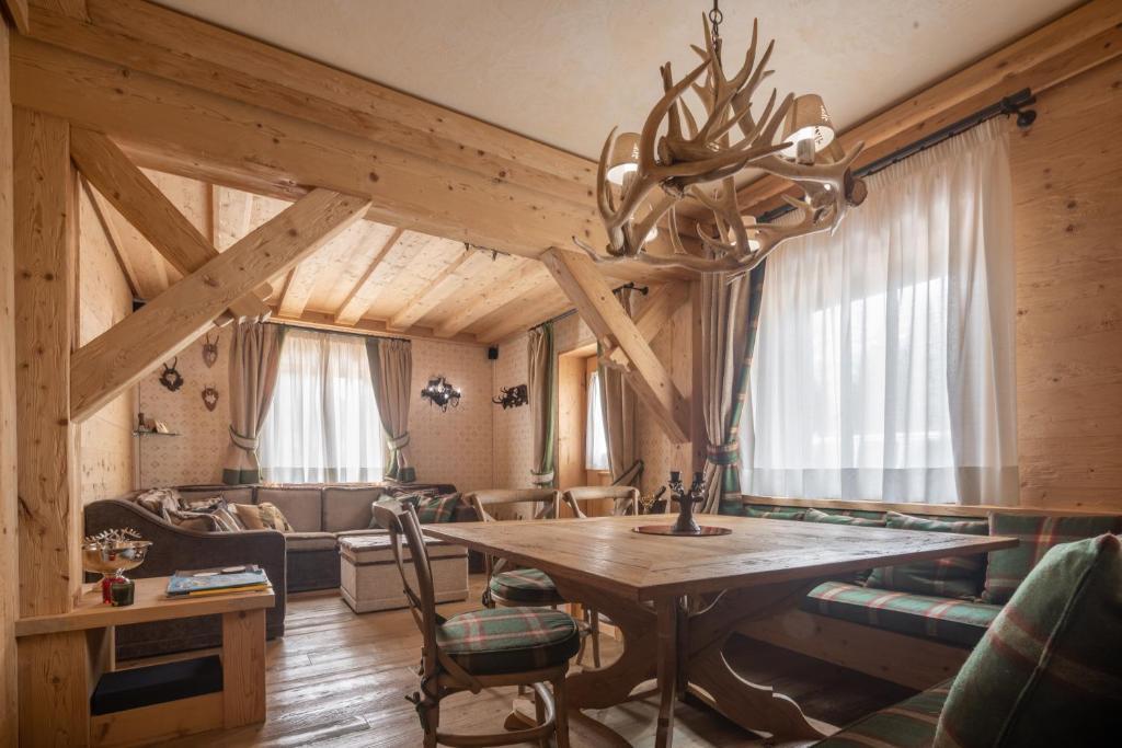 a living room with a table and a couch at Cortina Deluxe Chalet R&R in Zuel