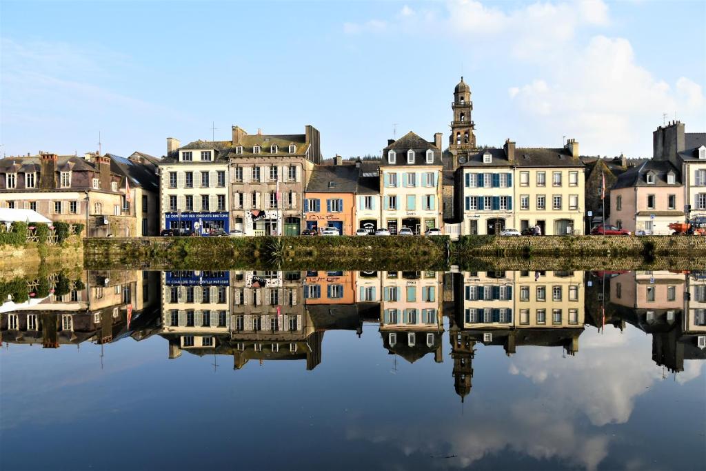 a city with buildings reflecting in the water at La Maison du Quai Triplex de charme 4 étoiles en hyper centre avec SPA in Landerneau