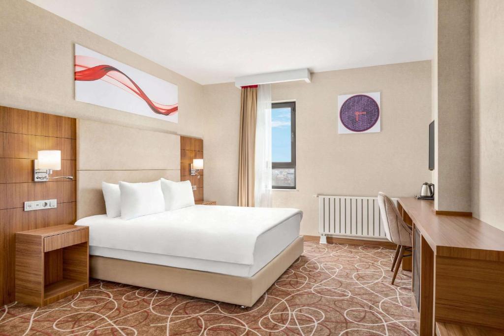 A bed or beds in a room at Ramada By Wyndham Elbistan