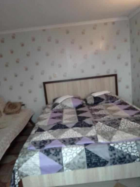 Postel nebo postele na pokoji v ubytování Гостевой дом Кристина