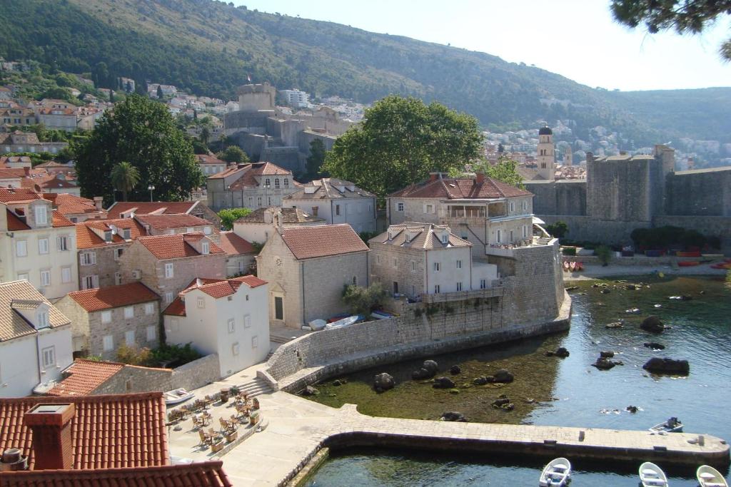 a view of a town with a river and buildings at Rooms Lovrijenac in Dubrovnik