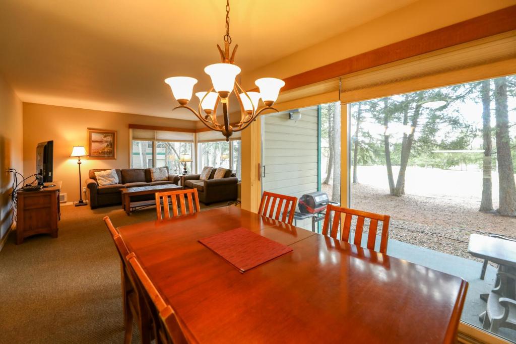 a dining room table and chairs in a room at Meadow Lake Resort & Condos in Columbia Falls