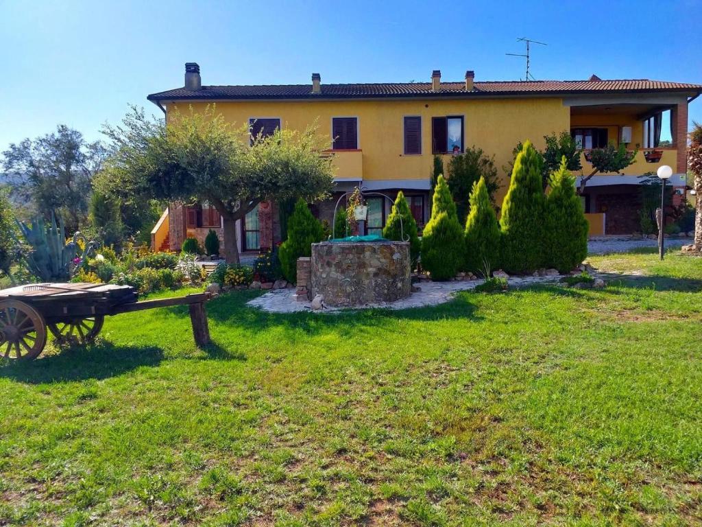 a house with a picnic table in front of it at Agribike Agriturismo Poggio Rossino in Gavorrano