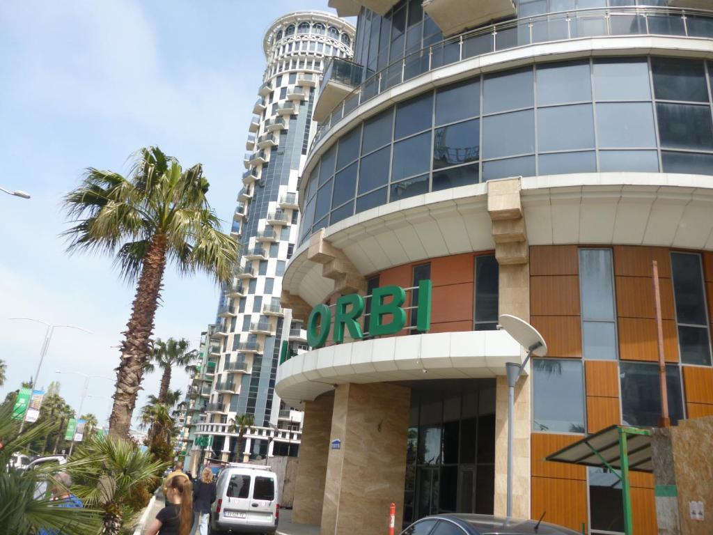 a building with a sign on the side of it at batumi orbi sea tawers in Batumi