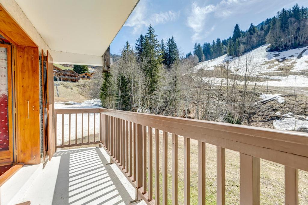 a balcony with a view of the snow covered mountains at La Loutre in La Giettaz