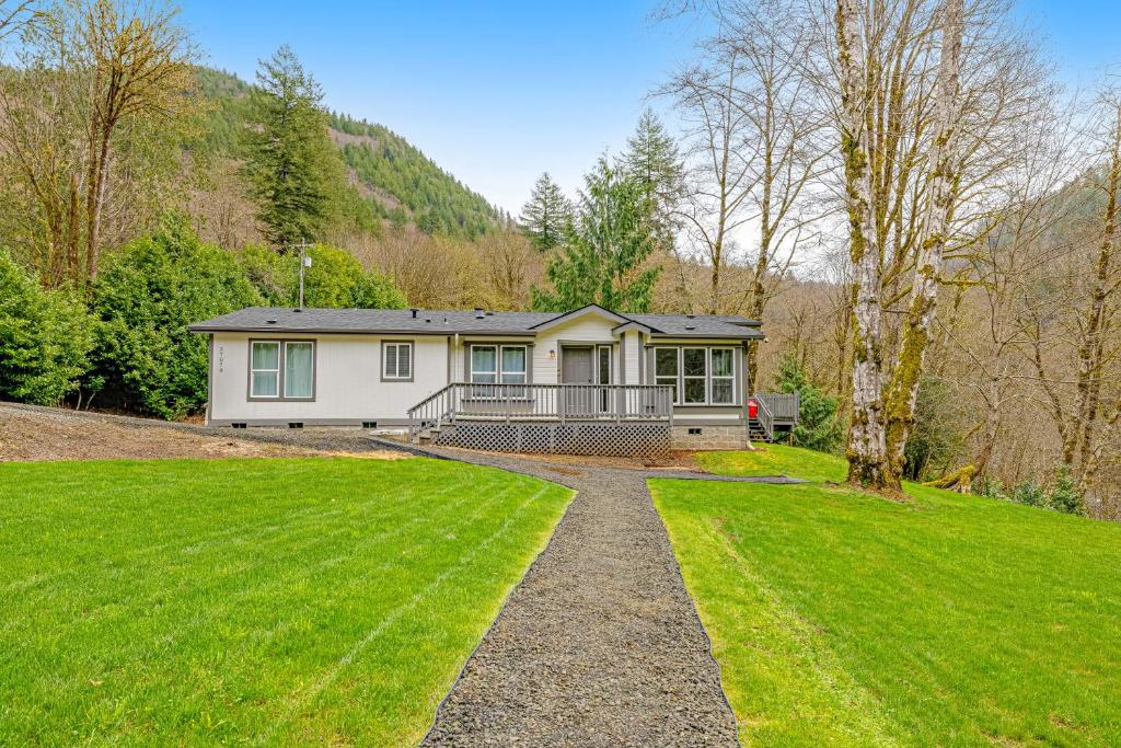 a house with a green lawn in front of it at RiverSong in Tillamook
