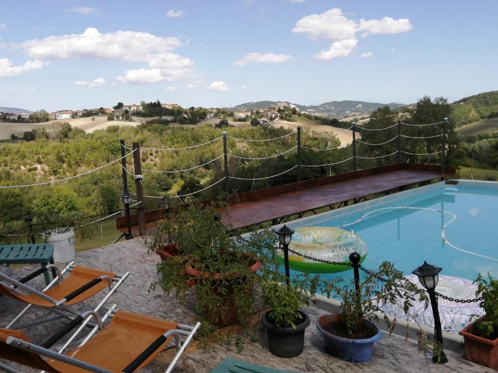a swimming pool with a fence around it at La Cascina di Muttley in Doglio